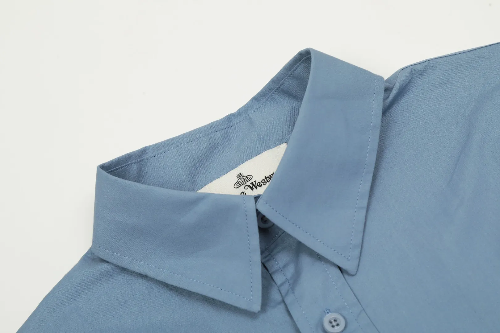 VIVI122 Uniform style for men and women" vivienne west wood Queen Mother Vivian Uniform style for men and women Casual suit style design shirt Metallic finishing touch on cuffs Folding sleeve design with high workmanship Double pressure line patch design on the hem The upper body has a stylish design sense The white background picture details display effect is average The real texture quality far exceeds the picture The 3 colors are very versatile Dark blue Black White Size: S M L